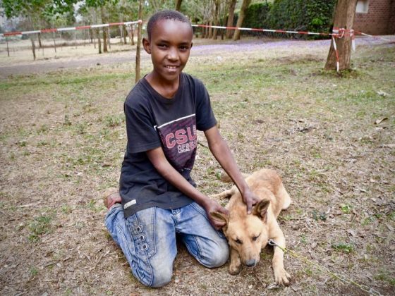 A young Tanzanian with his dog at FVAI clinic in Tanzania