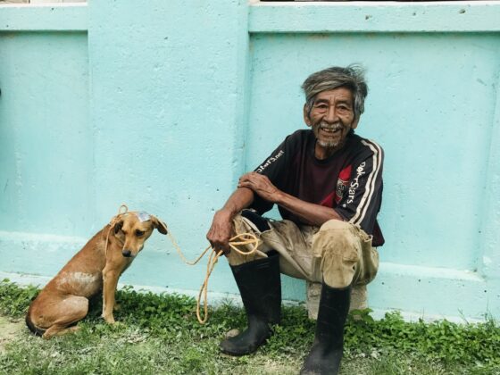 A villager and his little dog at FVAI's clinic in Sarteneja, Belize