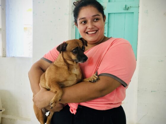 A Belizean and her little dog at FVAI's clinic in Sarteneja