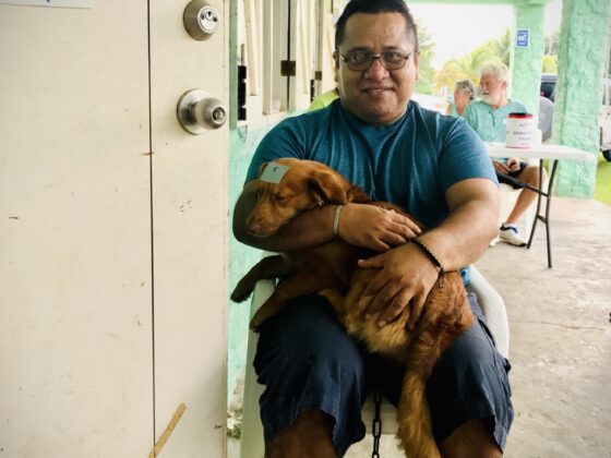 A Belizean and his dog at FVAI's clinic in San Joaquin, Belize