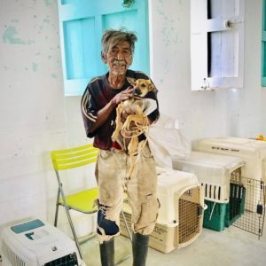 A villager and his pup in Sarteneja, Belize