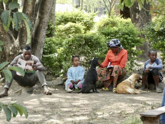 People wait patiently with their dogs at the FAVI clinic in Tanzania.